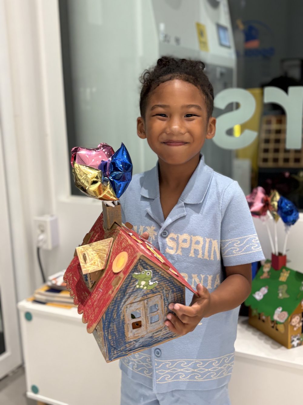 Child holding their craft
